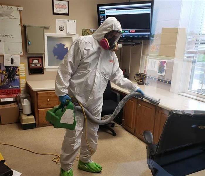 SERVPRO tech in PPE doing a cleaning