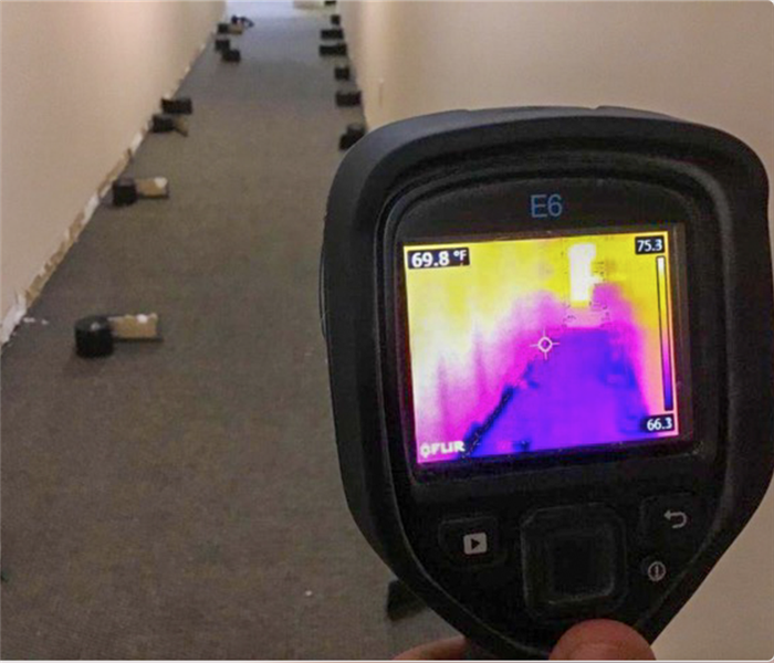 Infrared camera scanning hallway.