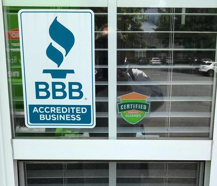Certified: SERVPRO Cleaned sticker on the window of a business